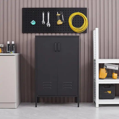 A closed black metal tool storage cabinet positioned below a wall pegboard in an organized garage setup.