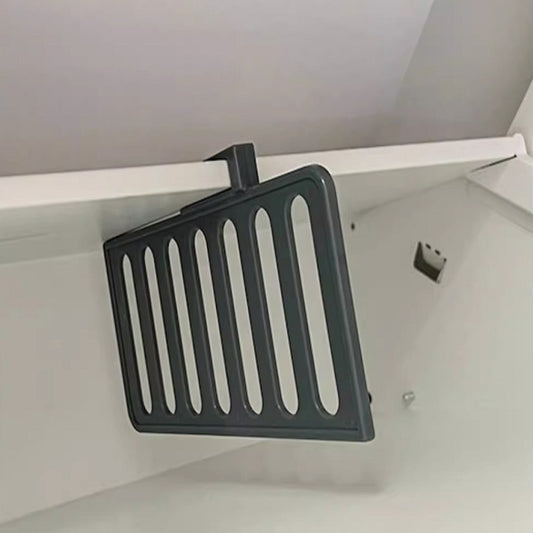 black shoe divider plate installed inside a white shoe rack
