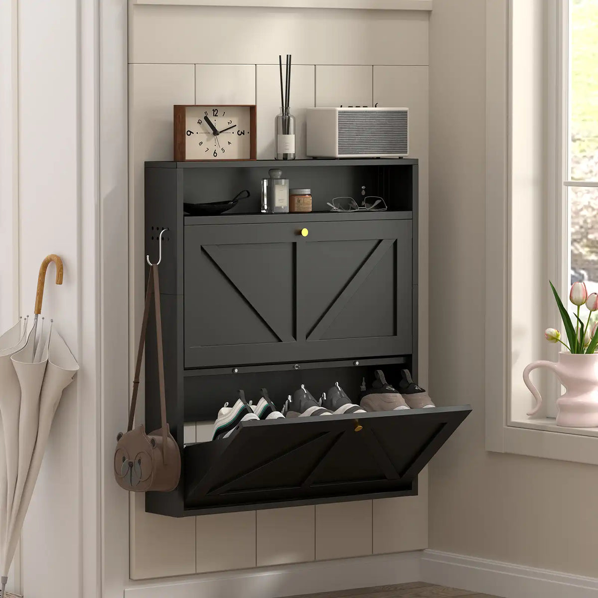 full view of the space-saving black shoe organizer standing against a clean light-colored hallway wall