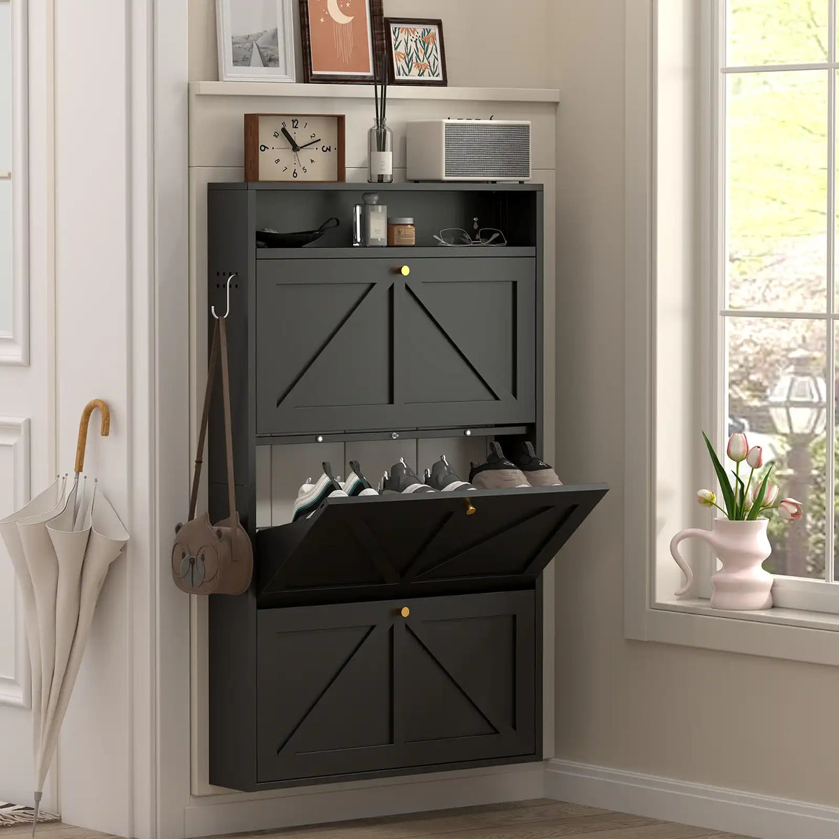 modern black 3-tier flip shoe cabinet with integrated side hanging hooks and an umbrella stand in a light-filled entryway #black #standard