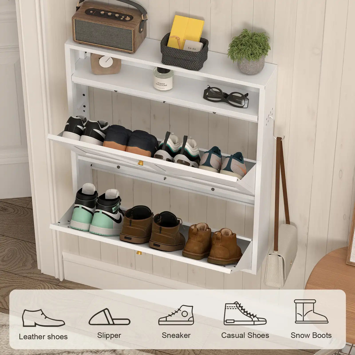 top shelf display of the white shoe cabinet showcasing small plants keys and decorative home accessories